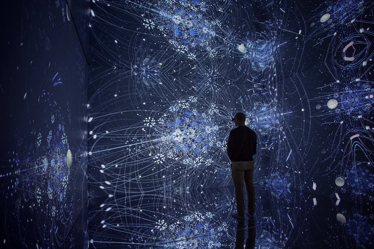 Visitor surrounded by immersive digital displays